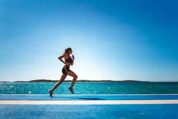 Woman running showing strong leg muscle Royal Leamington Spa